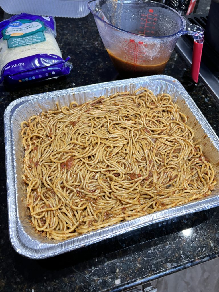 spaghetti with sauce in an baking pan