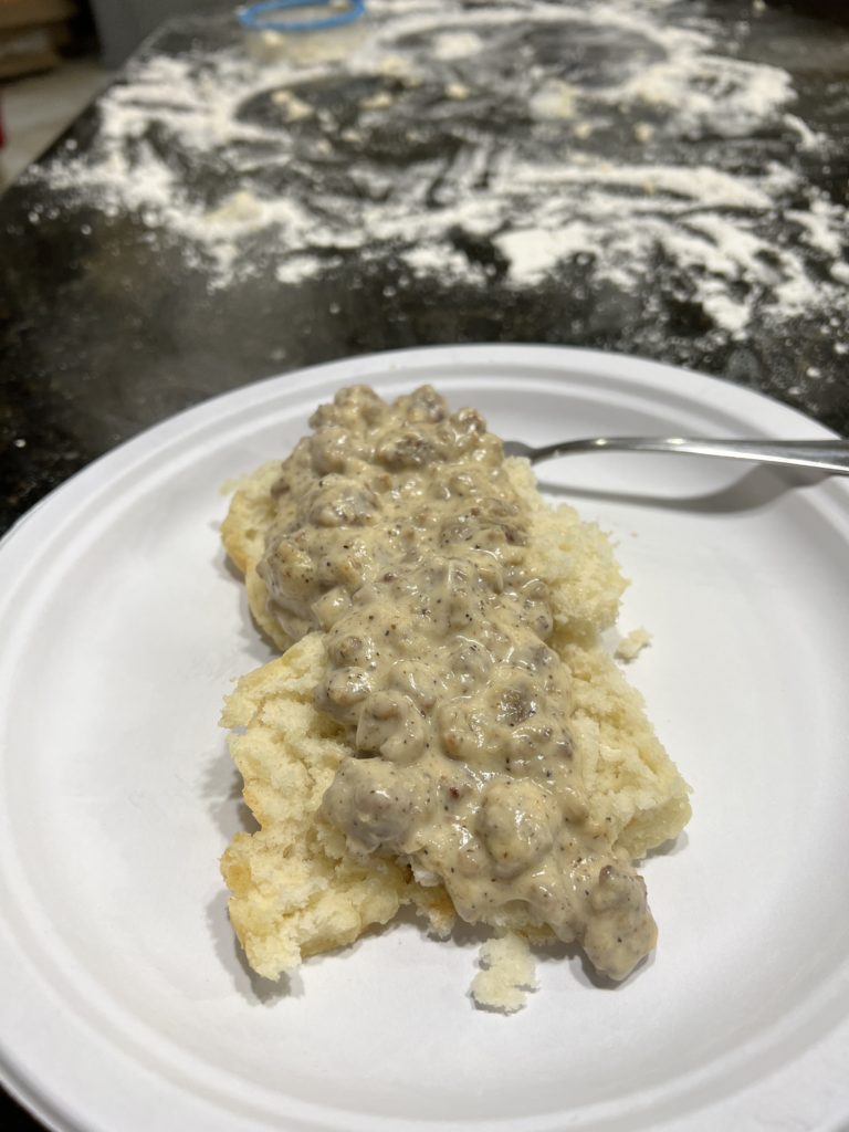 biscuits and gravy on a paper plate